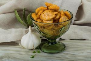 Croutons in a bowl on wooden background photo