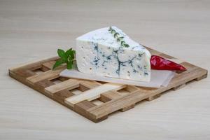 Blue cheese on wooden board and wooden background photo