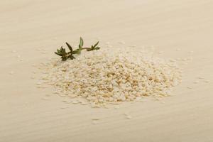 Sesame seeds on wooden background photo