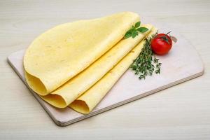 Tortilla on wooden board and wooden background photo