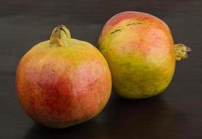 Yellow Pomegranet on wood photo