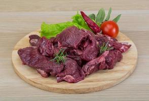 Raw venison on wood photo