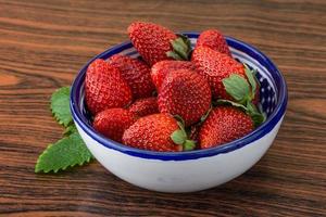 Fresh strawberry on wood photo