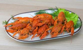 Boiled crayfish on wood photo