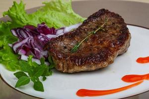 Beefsteak on the plate photo