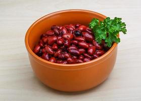 Baked beans in a bowl on wooden background photo