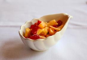 Fruit salad on white background photo