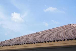 Ceramic roof tiles on the house with blue sky photo