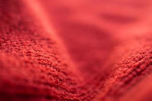 closeup red knitted woolen fabric texture background photo