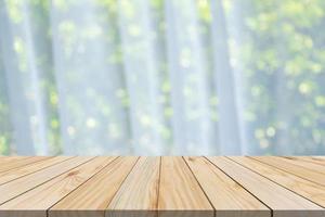 Empty wood table top with blur window curtain background for product display photo