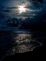 Beach night scene with moonlight photo