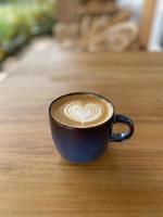 Heart latte art on coffee cup photo