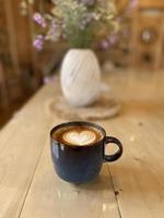 Heart latte art on coffee cup photo