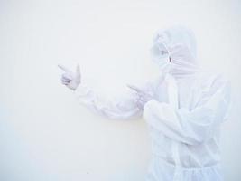 Asian male doctor or scientist in PPE suite uniform showing pointing two fingers away at copy space while standing and looking forward. coronavirus or COVID-19 concept isolated white background photo