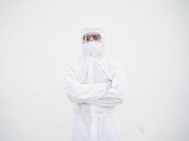 Portrait of confident asian male doctor or scientist in PPE suite uniform while folding his hands in the white background. coronavirus or COVID-19 concept. photo