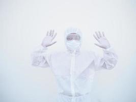 Asian male doctor or scientist in PPE suite uniform showing stop sign while looking ahead. coronavirus or COVID-19 concept isolated white background photo