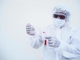 Asian doctor or scientist in PPE suite uniform. Personal protective equipment suit dropping a blood into blood test tube. coronavirus or COVID-19 concept isolated white background photo