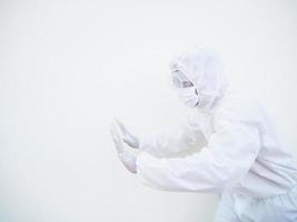 Asian doctor or scientist in PPE suite uniform showing pushing invisible something for text or design on a white background. coronavirus or COVID-19 concept photo