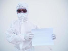 Young doctor or scientist in PPE suite uniform holding blank paper for text with both hands While looking ahead. coronavirus or COVID-19 concept isolated white background photo