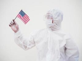 Portrait of doctor or scientist in PPE suite uniform holding national flag of United states of America. COVID-19 concept isolated white background photo