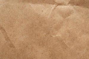 Brown crumpled paper recycled kraft sheet texture background photo