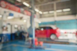 Red car lift at maintenance station in automotive service center blur abstract background photo