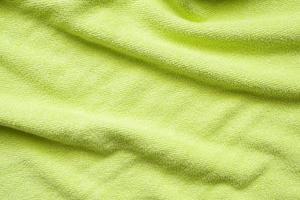 Green towel fabric texture surface close up background photo