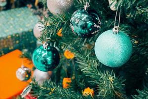 Decorated Christmas tree with colorful bauble on sparkling bokeh light blurred background photo