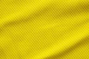 Color amarillo camiseta de fútbol ropa tela textura ropa deportiva fondo, primer plano foto