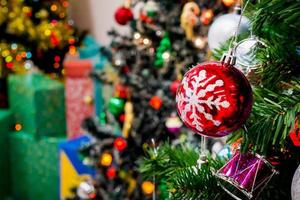 Decorated Christmas tree with colorful bauble on sparkling bokeh light blurred background photo