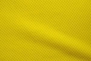 Yellow color football jersey clothing fabric texture sports wear background, close up photo