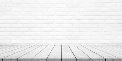 Empty white wood table top with brick wall background photo
