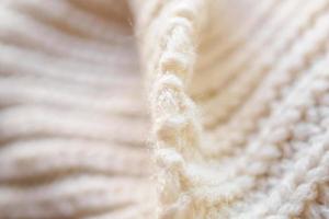 closeup beige knitted woolen fabric texture background photo
