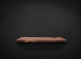 Light wood shelves on black wall texture in loft Style  background with clipping path. Design for wallpaper photo