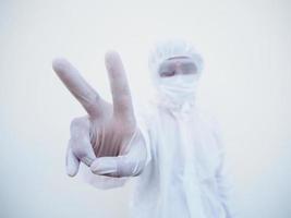 Doctor or scientist in PPE suite uniform  showing fight hand sign. coronavirus or COVID-19 with looking forward isolated white background photo
