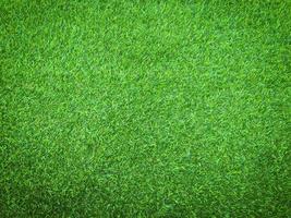 Closeup view of green grass soccer field background. Wallpaper for work and design. photo