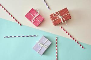 present boxes with ribbon on pink canvas background photo