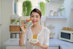 Girl eating fresh spring rolls with shrimps photo