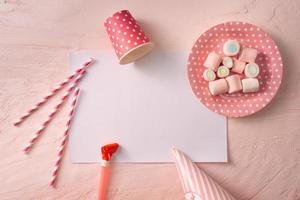 Party management and organization concept with sweets, confetti and blank pages. Creative celebration flat lay with copy space. photo