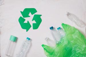 waste recycling eco symbol with garbage disposal on stone table background top view photo