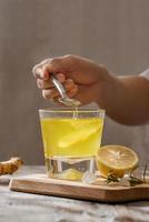 refreshing citrus lemonade,summer drink. Lemonade with fresh lemon on wooden background photo