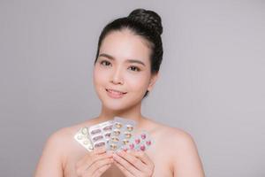 Beautiful Smiling Woman Holding Blister Packs With Pills In Hand photo