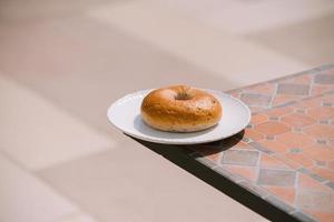 Breakfast Morning Sunny warm weather with donut on white plate on table background. Good mood Horizontal view photo