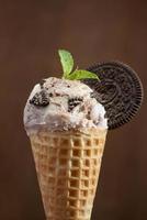 Sweet homemade ice cream with cookies in cone, selective focus photo