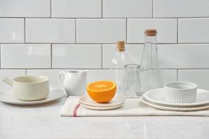 Orange in a dish on the table in the kitchen photo