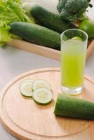 Vegan diet food. Detox drinks. Freshly squeezed juices and smoothies from vegetables. On white background, wooden tray, ingredients. Copy space photo