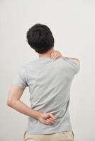 Man rubbing his painful back close up. Business man holding his lower back. Pain relief, chiropractic concept photo