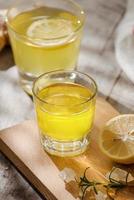 refreshing citrus lemonade,summer drink. Lemonade with fresh lemon on wooden background photo