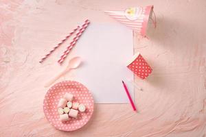 Party management and organization concept with sweets, confetti and blank pages. Creative celebration flat lay with copy space. photo