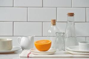 Orange in a dish on the table in the kitchen photo